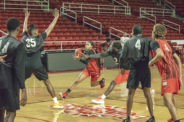 Shedricka Pierson, sophomore guard, top, battles through defenders on her way to the net. UP photos by Lakota Jaton