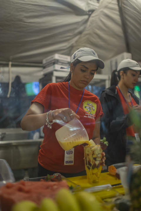 A local vendor, top left, makes smoothies out of their tent. UP photo by Noah Dawlearn