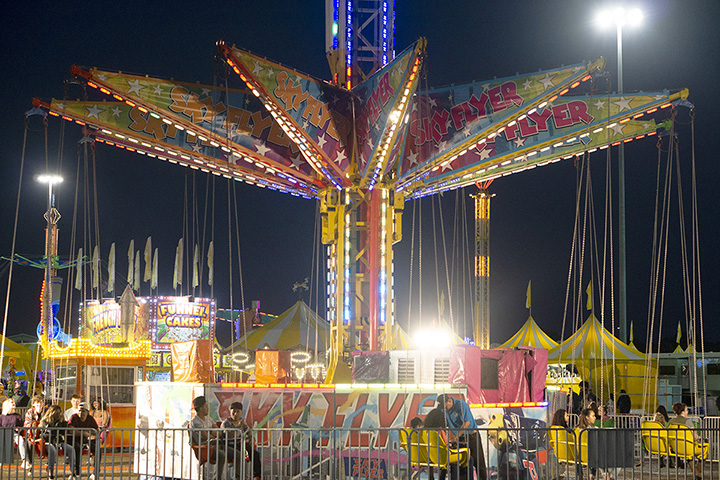 The sky fly, above, is a popular ride as it takes participants high in the sky in swings. UP photo by Cassandra Jenkins