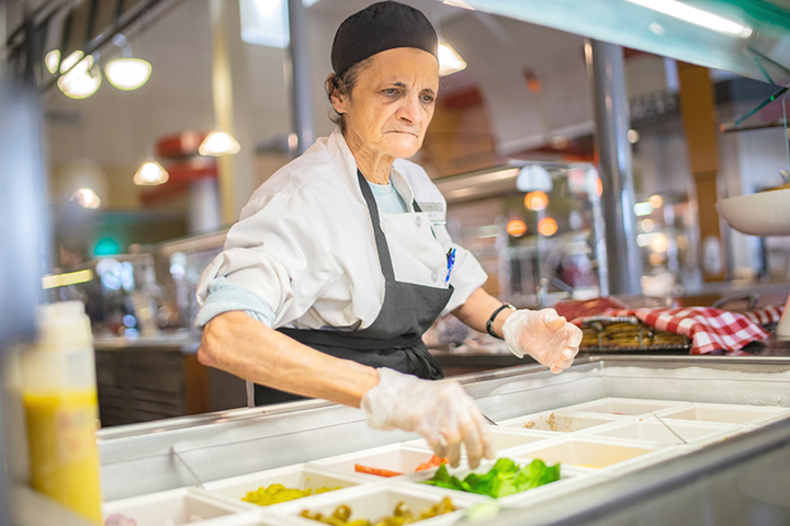Annette Bonura serves sandwhich’s at the deli Station in the Dining Hall. Tuesday. UP photo by Noah Dawlearn