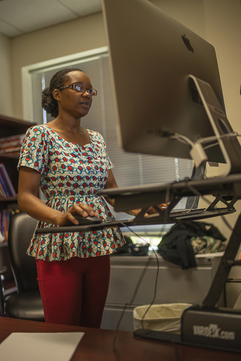 Gloshanda Lawyer, university professor, explains that sometimes she uses up to four different screens to during her work day in her office in the communications building, March 27. UP photo by Noah Dawlearn