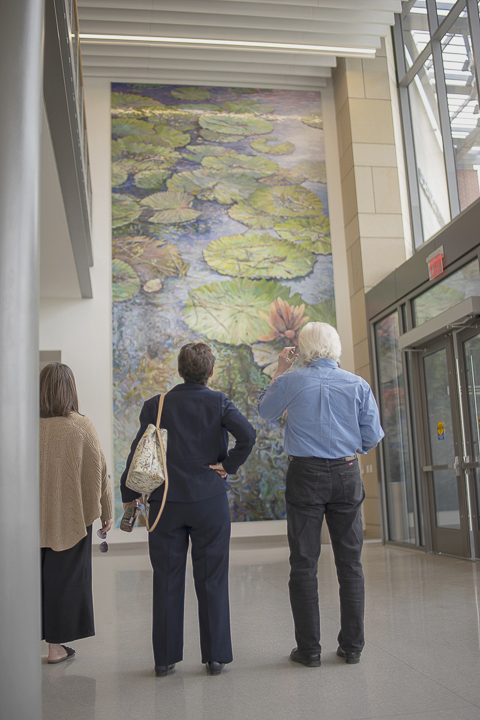 Visitors view the mosaic mural, featured in the new Science and Technology Building, Wednesday. UP photos by Noah Dawlearn