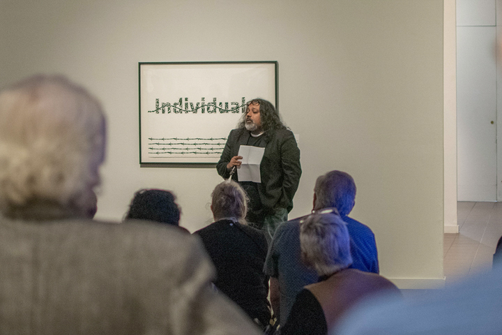 Lamar University art department professor, Prince Varughese Thomas, conducts a gallery talk during a reception for his exhibition, “The Legacy of Narcissus,” at the Art Museum of Southeast Texas, Oct. 4.