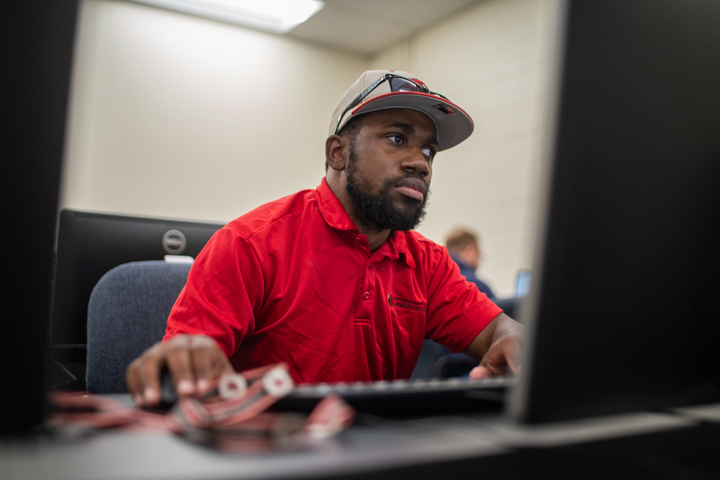 Jamarcus Corks, financial aid specialist, sets up a computer to help students fill out their FASFA in the Galloway Business Building, Oct. 22. UP photo by Noah Dawlearn