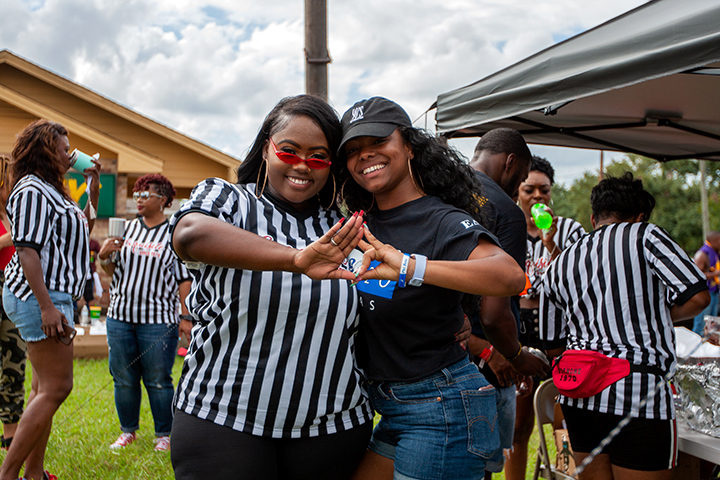 LU students pet a German-Shepherd as they wait for the night’s homecoming game at the Provost Umphrey Stadium. UP Photo by Delicia Rocha