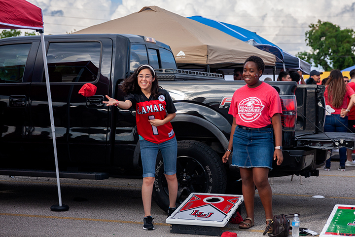 Students play a round of cornhole as they wait for the homecoming game to begin at the Provost Umphrey Stadium. UP Photo by Delicia Rocha