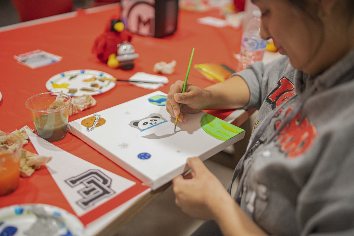  Lamar Students paint dorm room decorations at LU Spirt night in the Setz Student center Parking lot last Tuesday night. UP Photo by Noah Dawlearn