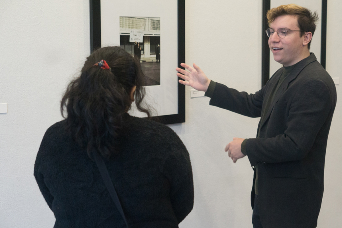 Tommy Duran talks to a visitor at the opening of his photography exhibition, “Obscurity of a Moment,” at the Art Museum of Southeast Texas, Feb. 6. Duran’s show includes the image below. UP photo by Cade Smith