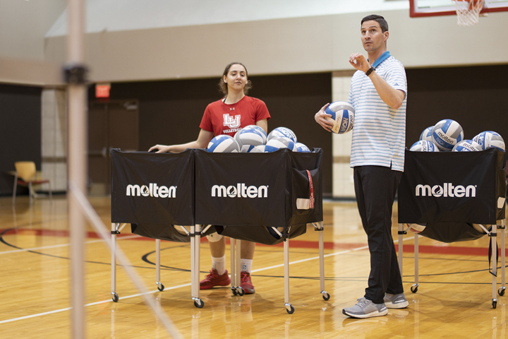 Jordan Lay, Lamar’s new head volleyball coach, runs drills with players in the McDonald Gym, Feb. 4. UP photo by Noah Dawlearn