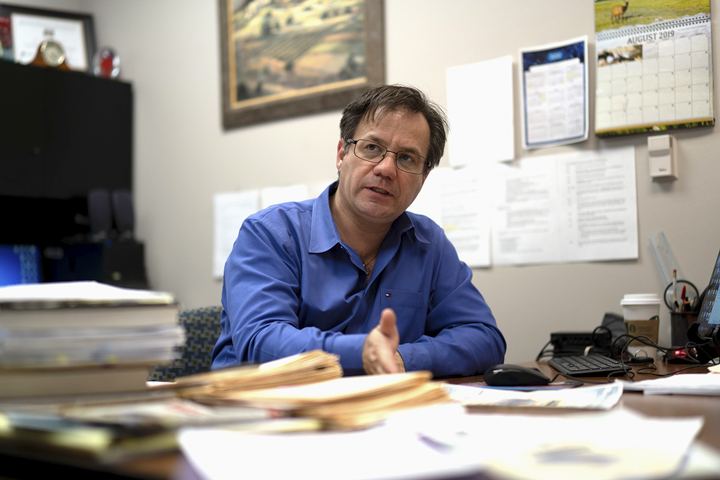 Cristian Bahrim talks about the physics conference in his office at Lamar, March 5. UP photo by Noah Dawlearn