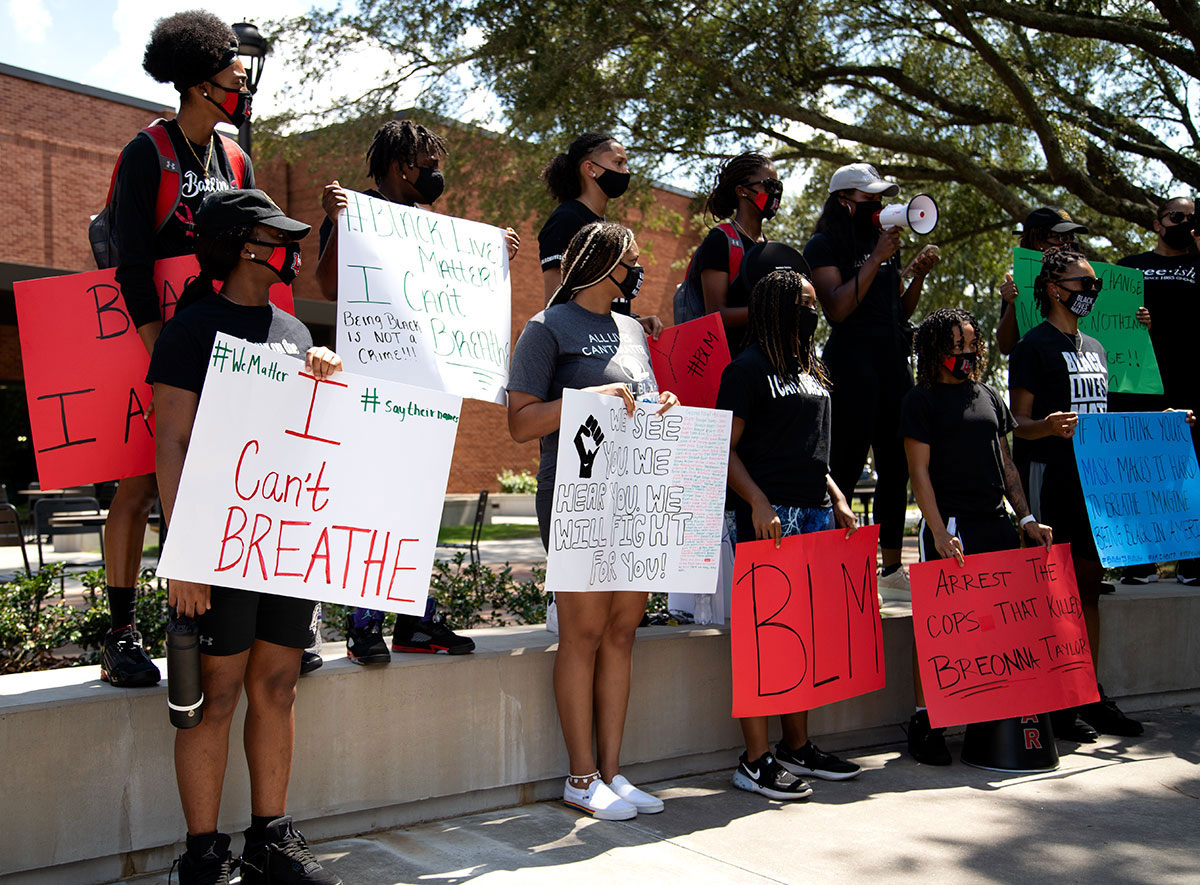 Members of the women’s basketball team hold protest signs and prepare to start the march at the Black Lives Matter rally outside of the Sheila Humphrey Recreational Center on Sept. 10. UP Photo by Delicia Rocha