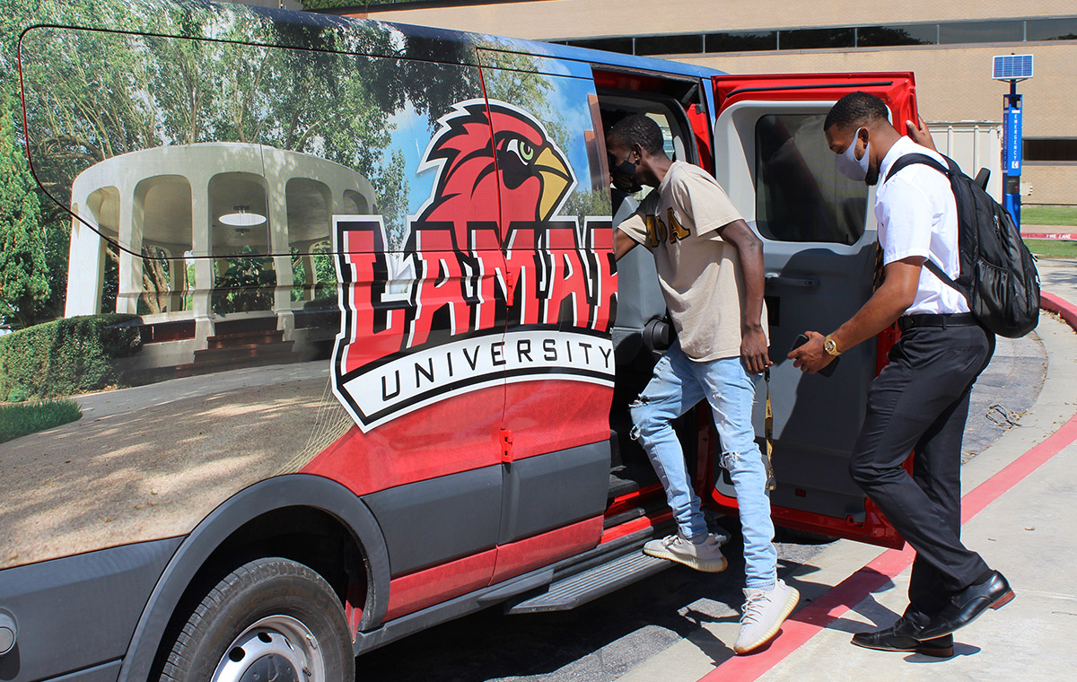 SGA president Trevion Wilson, right, joins students on the shuttle headed to the Jefferson County Courthouse to vote, Oct. 13. UP photo by Olivia Malick