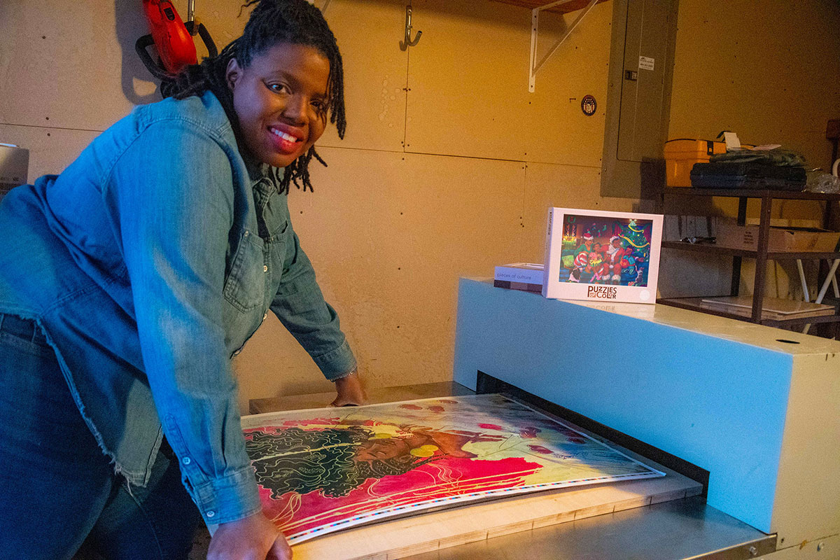 Ericka Chambers works on a machine cutting puzzle pieces.
