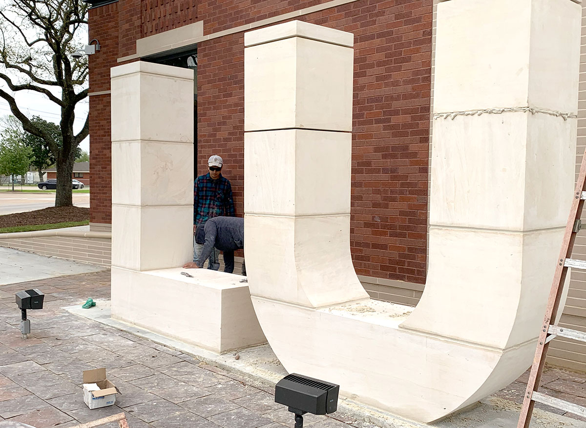 Workers put the finishing touches to the LU stone sign outside the new Welcome Center. UP photo by Tim Cohrs