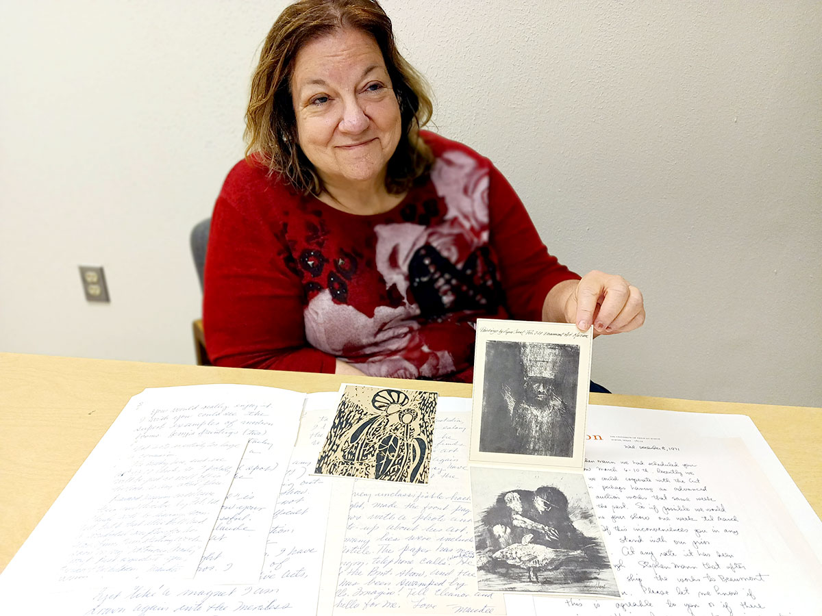 Penny Clark shows off pieces from Lynn Sweat's donation to Gray Library.