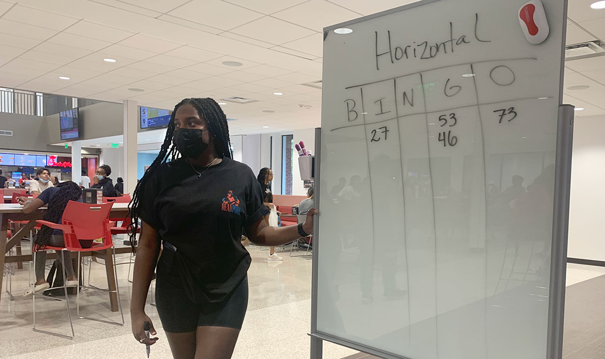 Takeena Simpson, Cardinal Communities peer mentor, displays the numbers during Bingo Night, Aug. 24, in the Setzer Student Center. UP photo by Havalyn Crawford