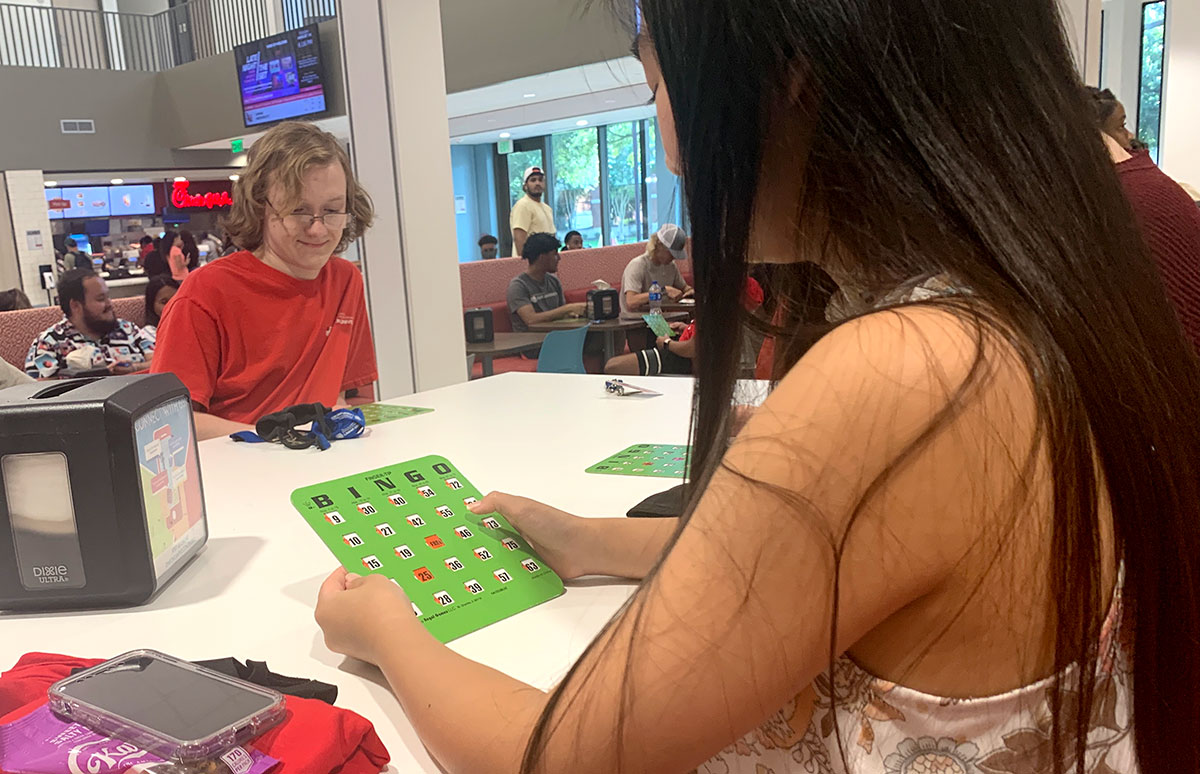 Ailinh Tran, Groves sophomore, checks her card during Bingo Night, Aug. 24, in the Setzer Student Center. UP photo by Havalyn Crawford