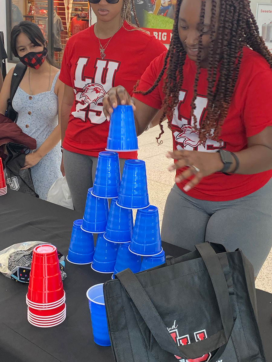 Christina Ware, Huntsville freshman, stacks cups during the Week of Welcome "Minute to Win It" event in the Setzer Student Center, Aug. 23. UP photo by Havalyn Crawford