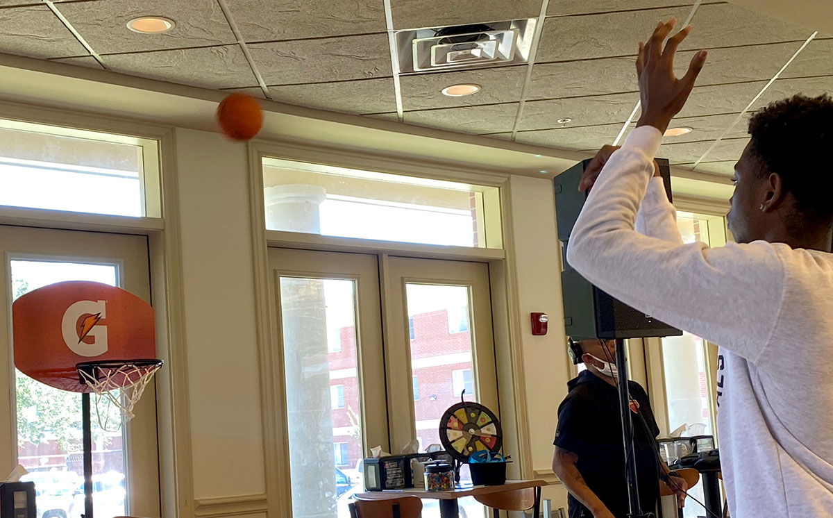 A student shoots a basketball for prizes during Food Festi-ful in Brooks-Shivers Dining Hall, Sept. 24. UP photo by Madelyn Sims