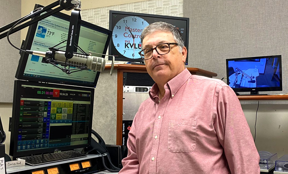 Byron Balentine, KVLU station manager, stands at the radio station control panel. Sept. 23.
