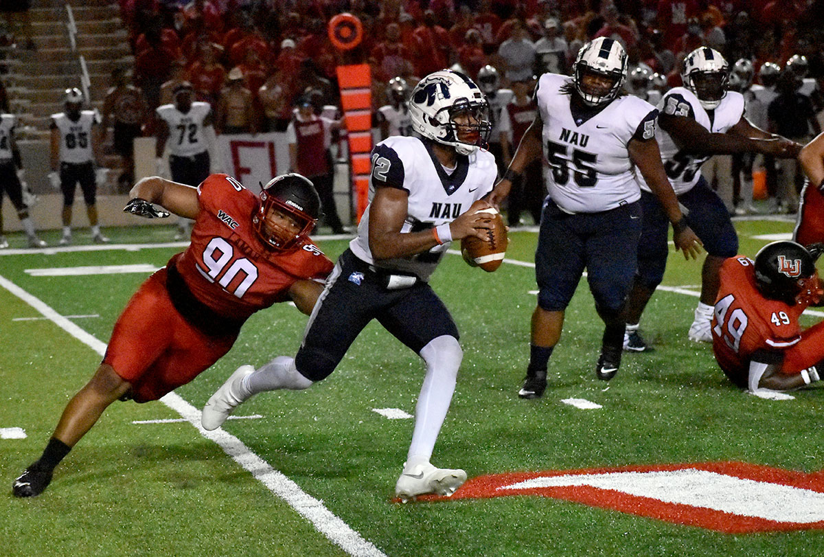 Tylo Phillips chases down NAU's quarterback during LU's 47-3 win over NAU at Provost Umphrey Stadium, Sept. 2. UP photo by Keagan Smith