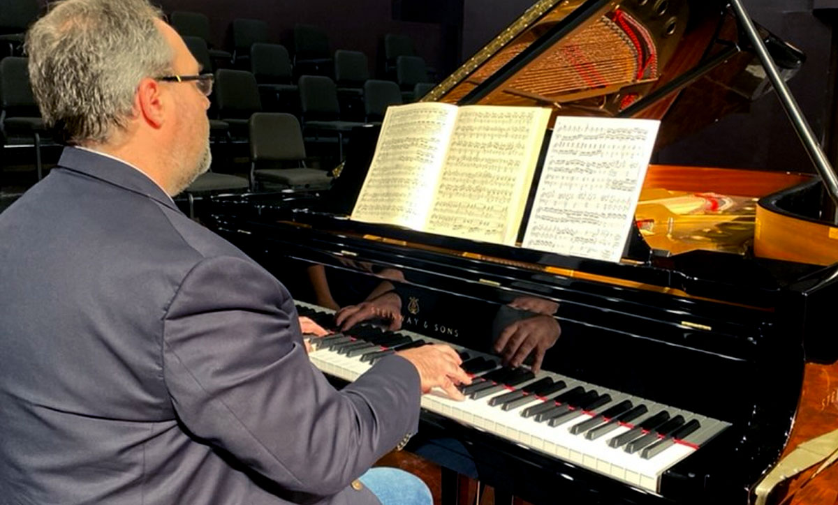 Jacob Clark, Piano Festival coordinator, rehearses in the Rothwell Recital Hall, Oct. 7. UP photo by Reina Morgan