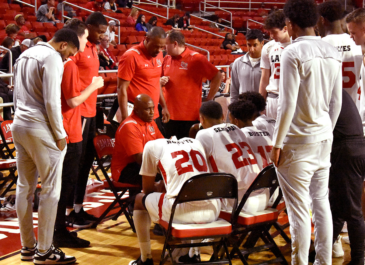 LU head basketball coach Alvin Brooks, seated center, lays out strategy during a timeout against OLLU in the Montagne Center, Dec. 5. UP photo by Keagan Smith
