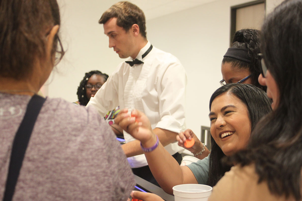 A student celebrates a winning hand during Casino Night, Aug. 23, in the Setzer Student Center. UP photo by Ambour Leal