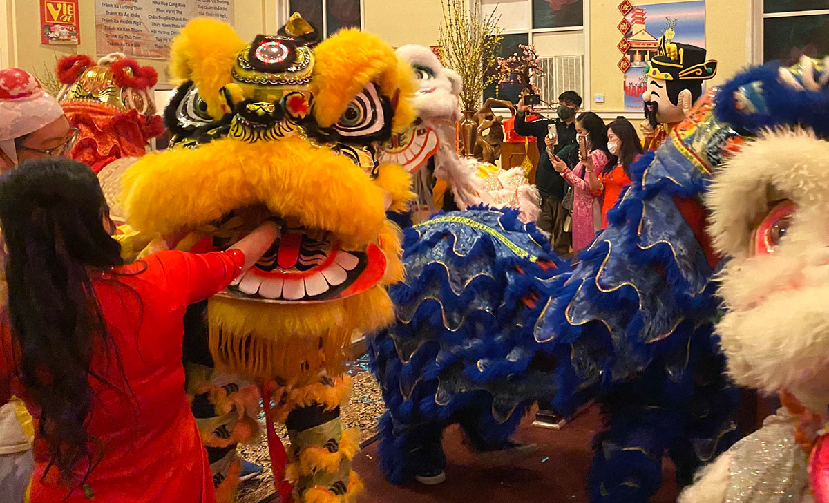 Participants put red envelopes with money in them in the mouths of Chinese lions.  The Port Arthur Lions celebrated Chinese New year, Feb. 1, at the Chua Buu Mon Buddhist Temple on Proctor Street in Port Arthur. UP photo by Clarissa Hernandez