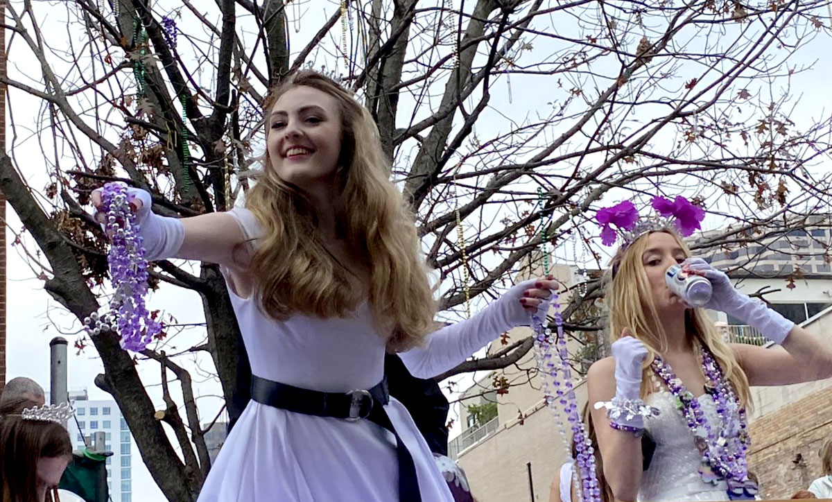 A girl throws beads from a float during the Krewe of Iris parade, Feb. 26, in New Orleans. UP photo by Maddie Sims