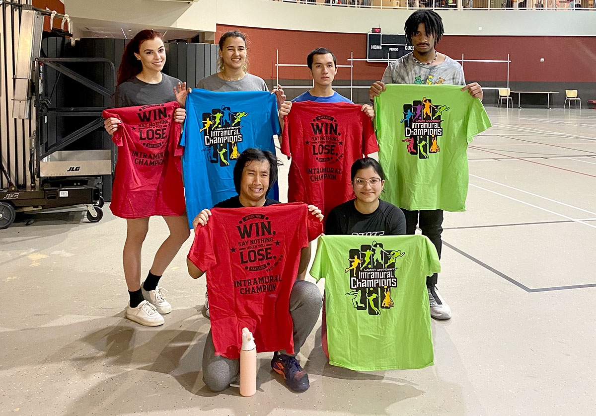 Members of team DN show off the T-shirts they earned for winning the Co-Rec volleyball tournament, Feb. 28, in the Sheila Umphrey Recreational Sports Center. UP photo by Clarissa Hernandez