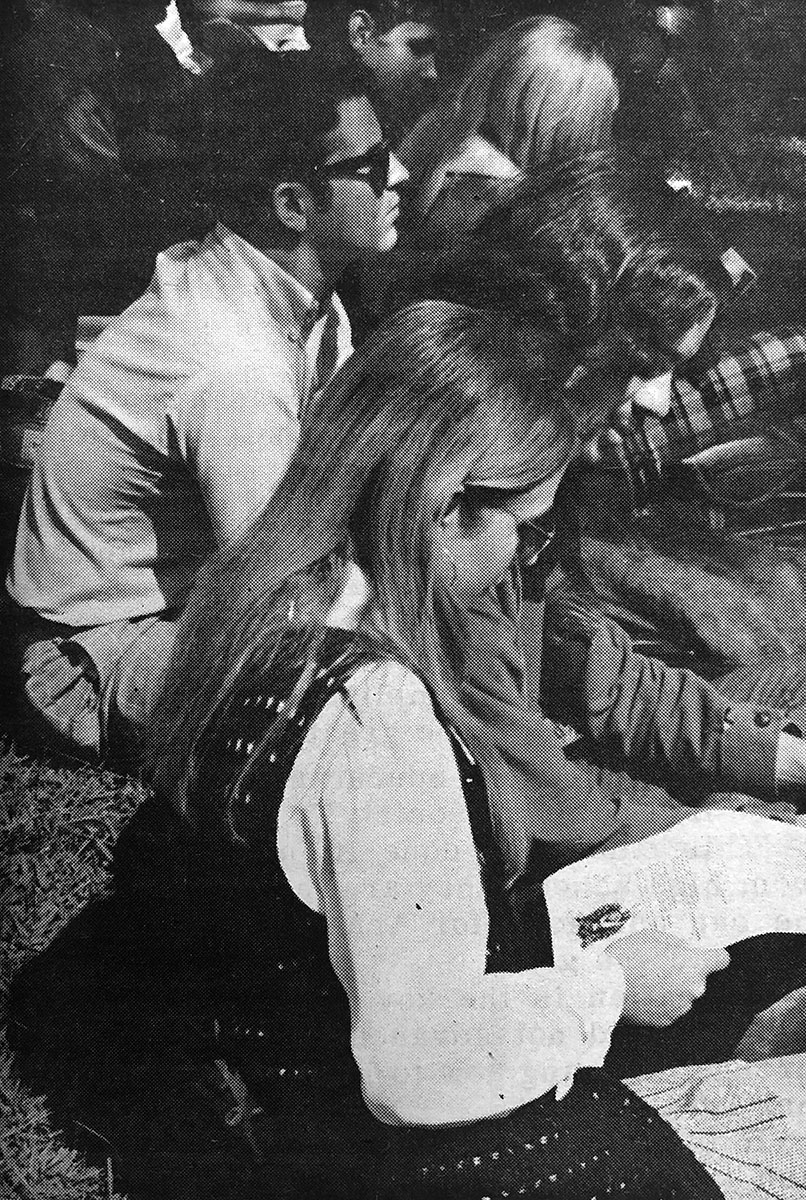 Singing--was part of the protest as various protest songs were sung during the rally. The pictured is singing from a copy of What's Left, an underground publication distributed Wednesday. (Staff photo by Bobby Dickinson)