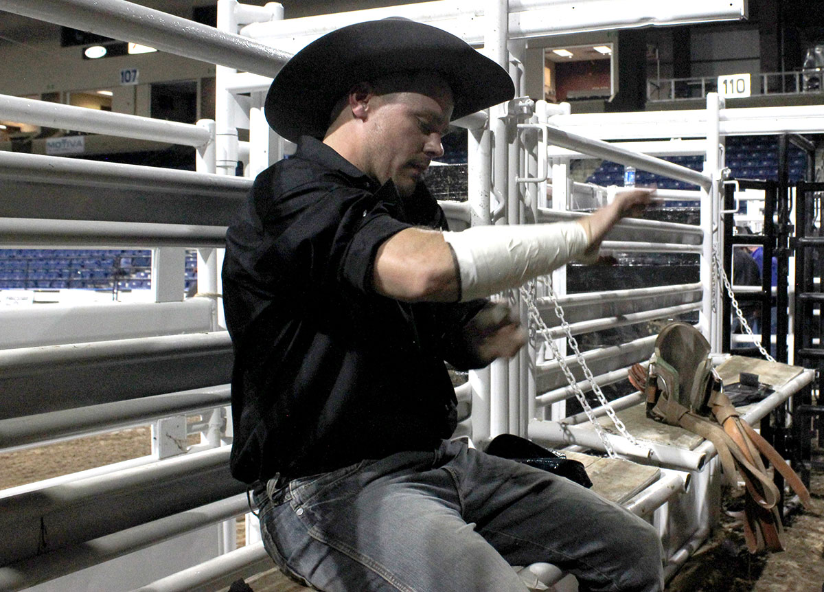 Kaleb Fusilier of Opelousas, Louisiana, prepares for his bull ride at the South Texas State Fair Saturday in Beaumont. Photo by Ginger Kovar.
