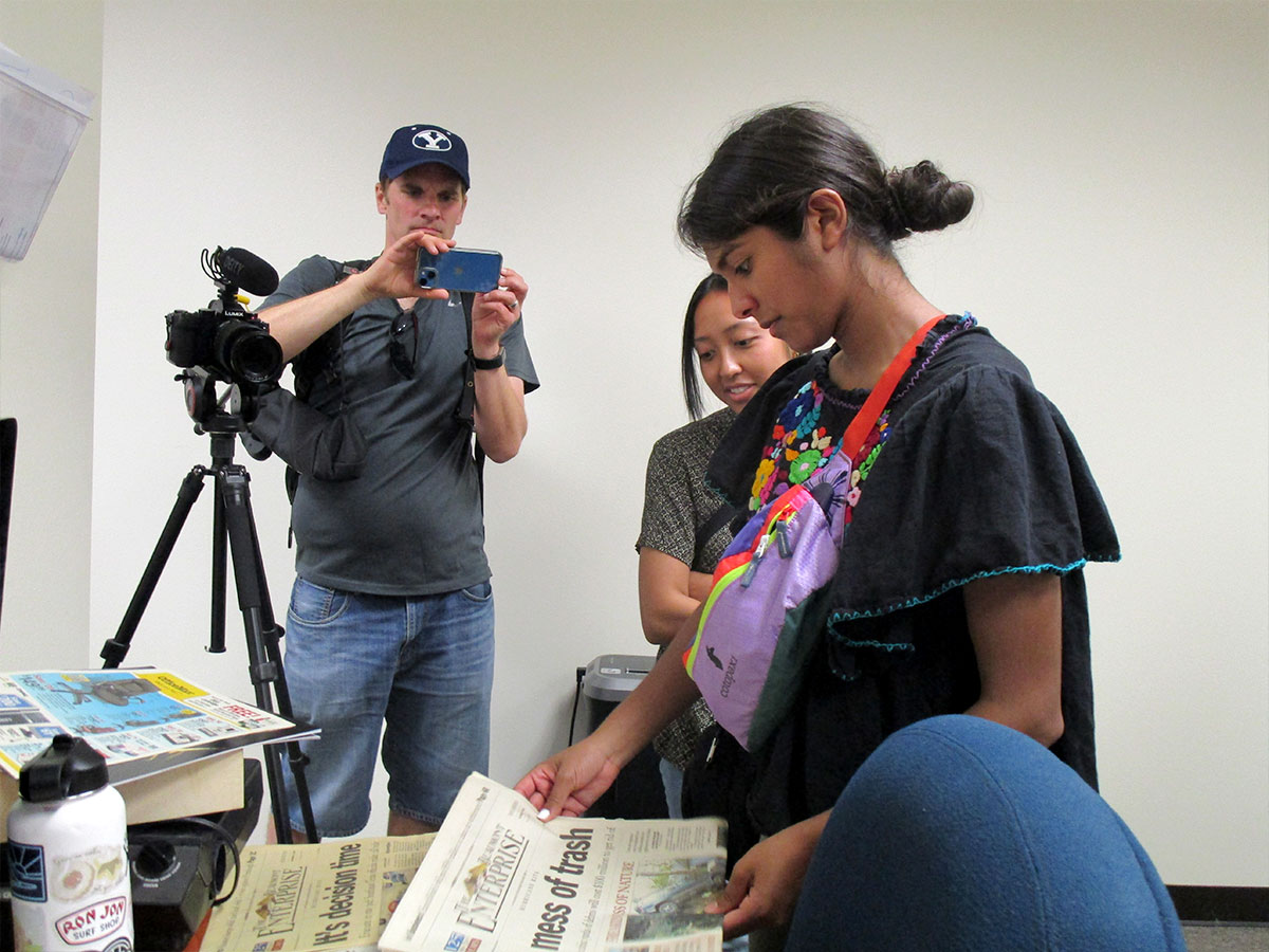 BYU students look through old newspapers at the University Press office. UP photo by Maddie Sims.