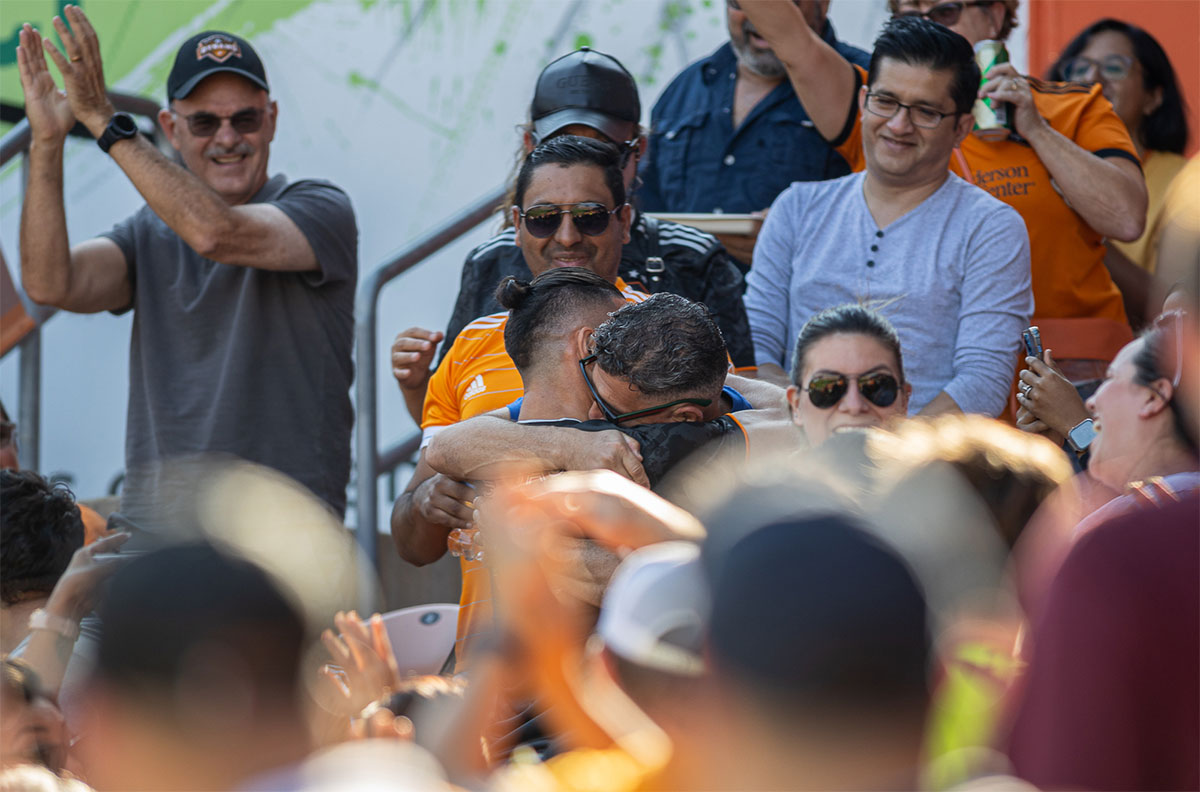 Houston forward, Sebastian Ferreira, hugs his father after scoring a goal as fans cheer at PNC stadium in Houston, Oct. 9. UP photo by Brian Quijada.