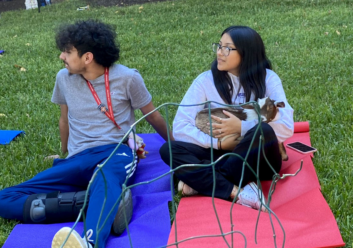 Students sit on yoga mats before the yoga session. UP photo by Maddie Sims.