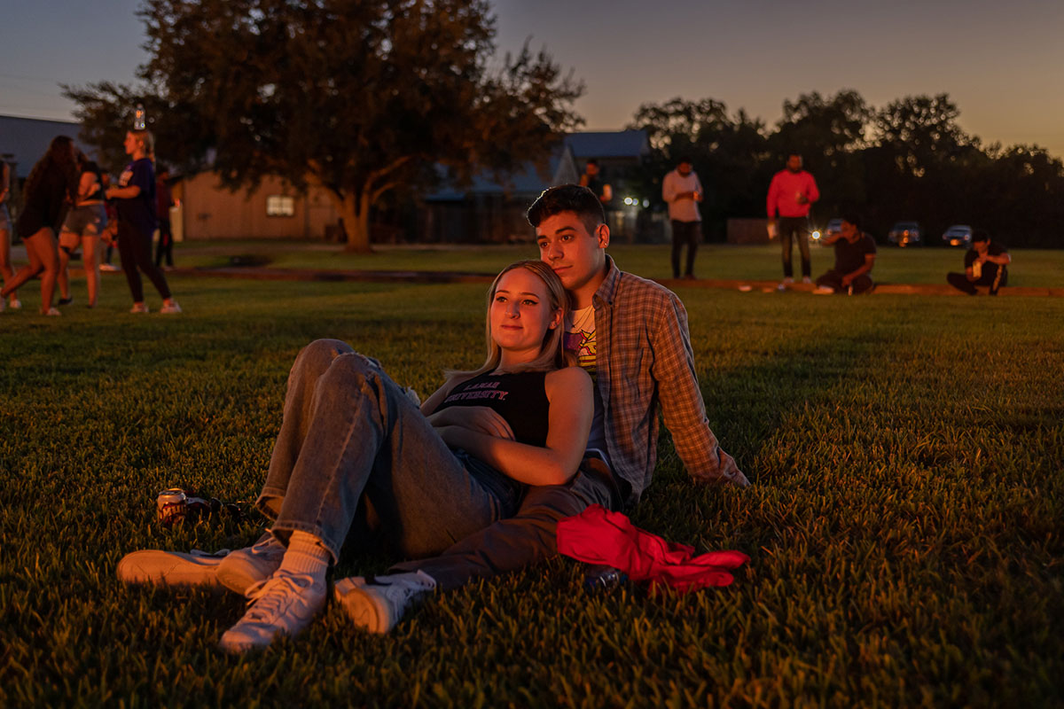 A couple sit in the glow of the bonfire during the Homecoming pep rally at the Spindletop-Gladys City Field, Sept. 30. UP photo by Brian Quijada.