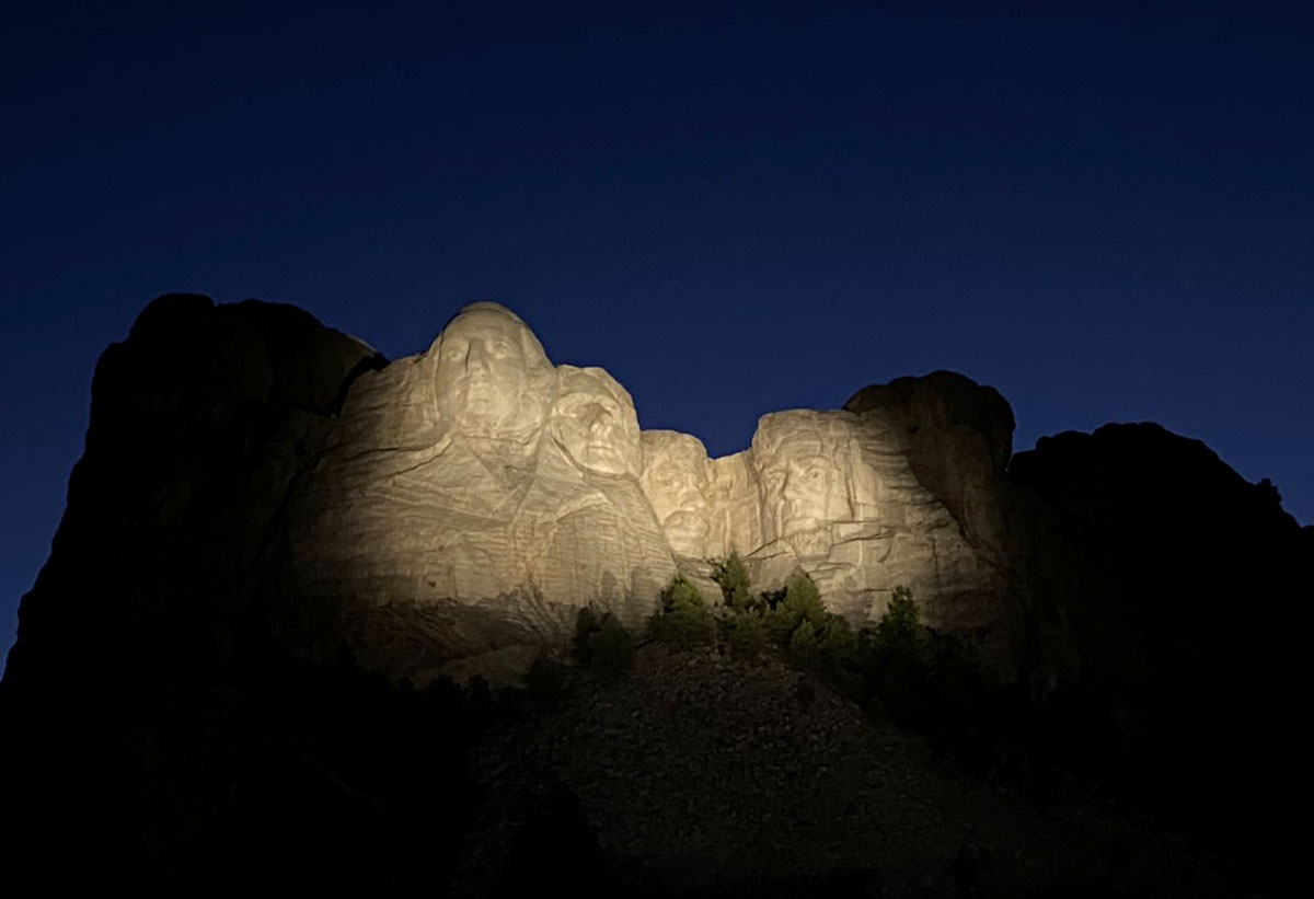 The statue's heads light up during the lighting ceremony at Mount Rushmore.