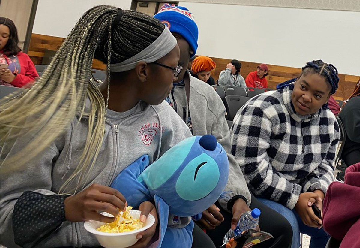 Students eat popcorn and chat before the prior to Movie Night Under the Stars in the Setzer Student Center, Jan. 20. UP photo by Maddie Sims