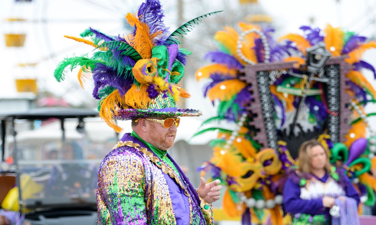 A man marches in a local Mardi Gras parade.
