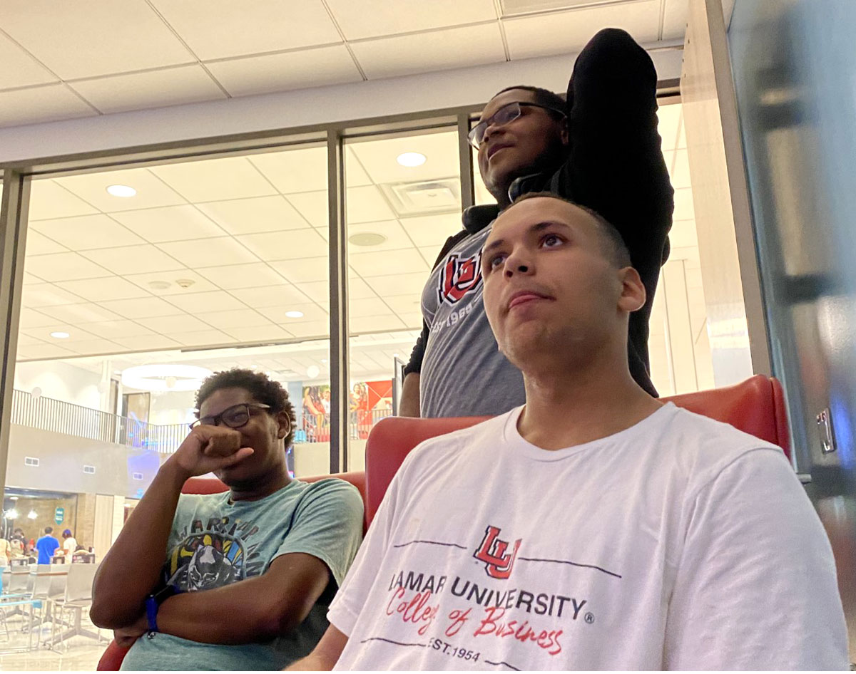 Christian Guillory plays video games with his friends, Lawrence Matthews (left) and Micah Jackson. UP photo by Maddie Sims. 