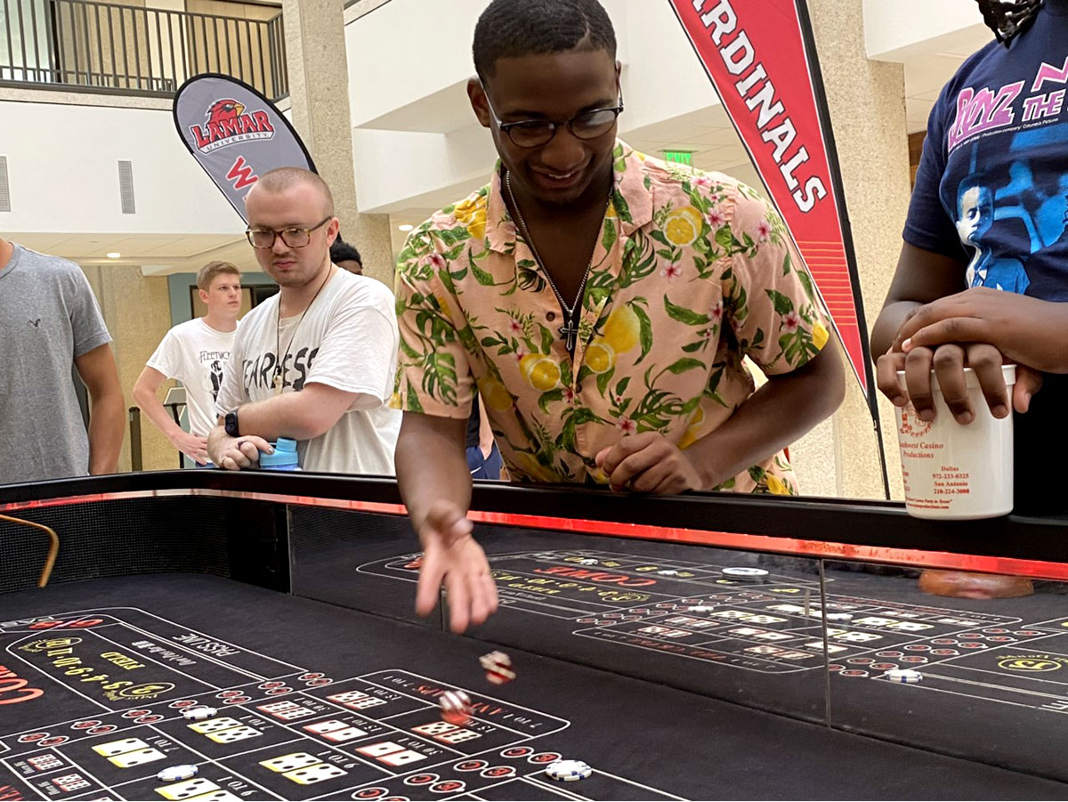 Daniel Mock, Angleton freshman rolls dice at Casino Night at the Student Setzer Center.