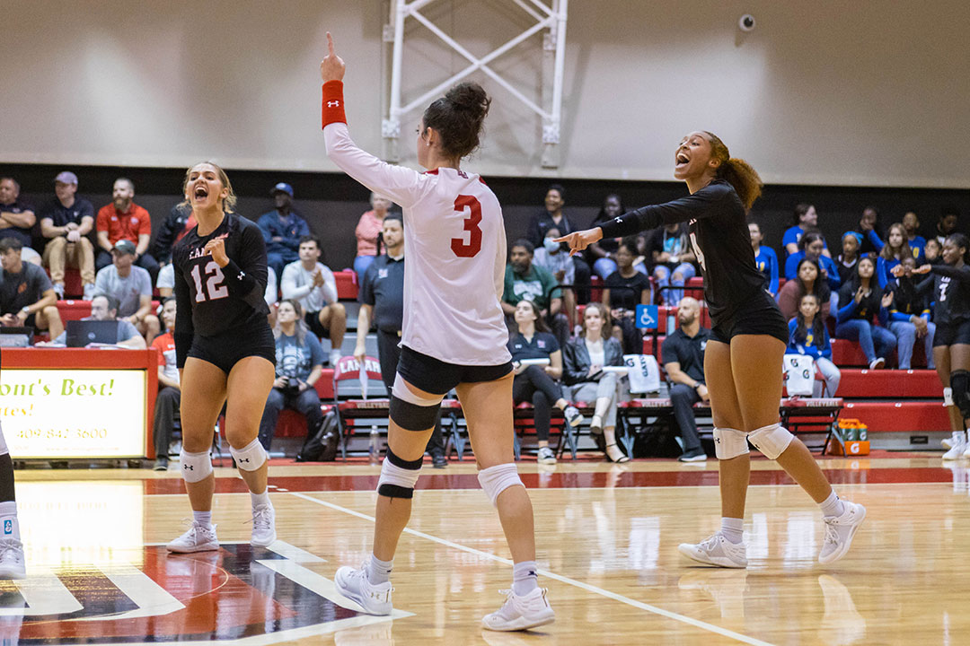 Lady Cards celebrate after rally win, Aug 26, at McDonald’s Gym. UP photo by Brian Quijada