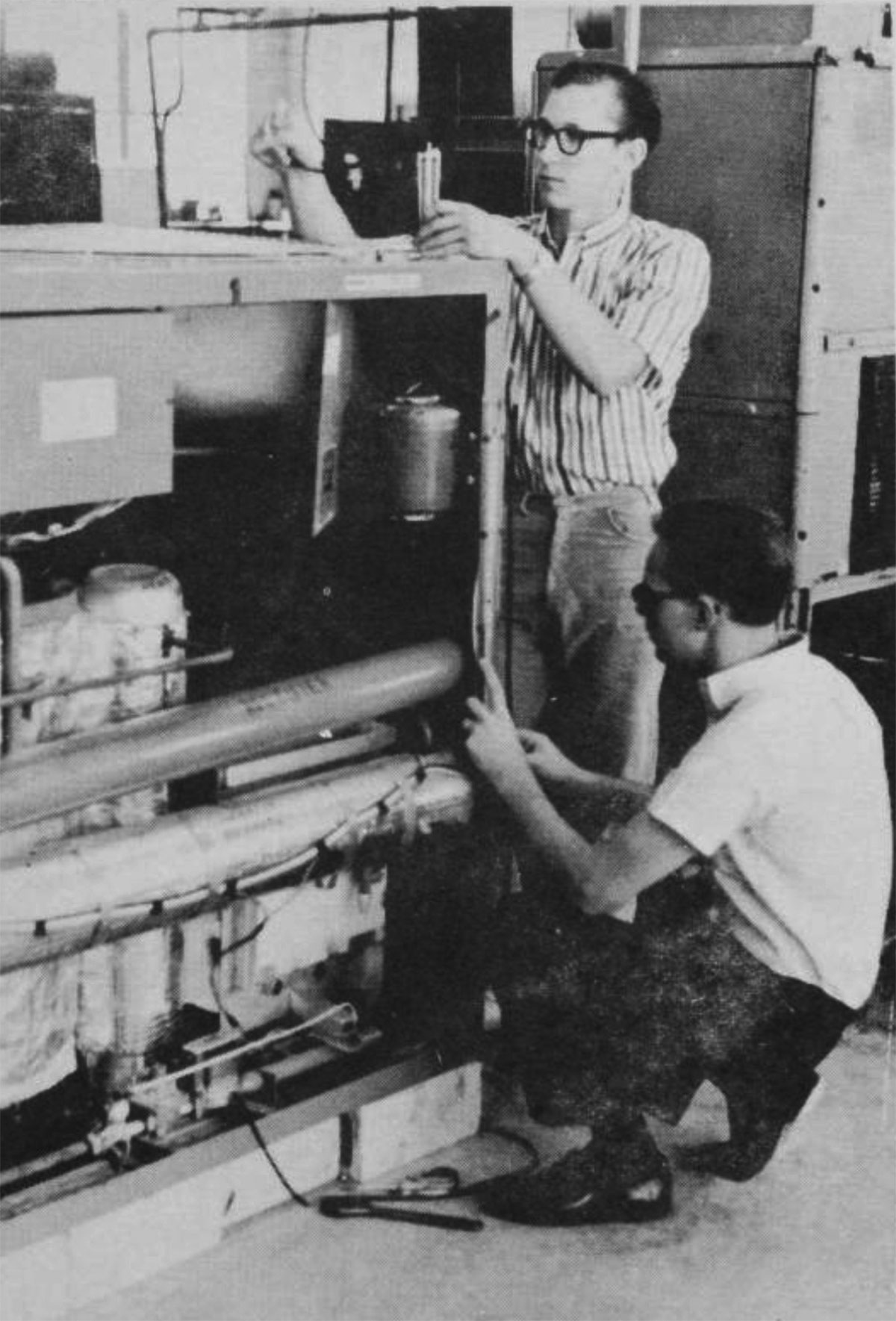 REFRIGERATION LAB—Steve Fox and Dixon Hebert, students in the school of vocations, work on a gas air conditioning unit during one of their lab sessions. The theory studied in classroom assignments is given practical application during the lab sessions. (Photo by Phillip Burr)