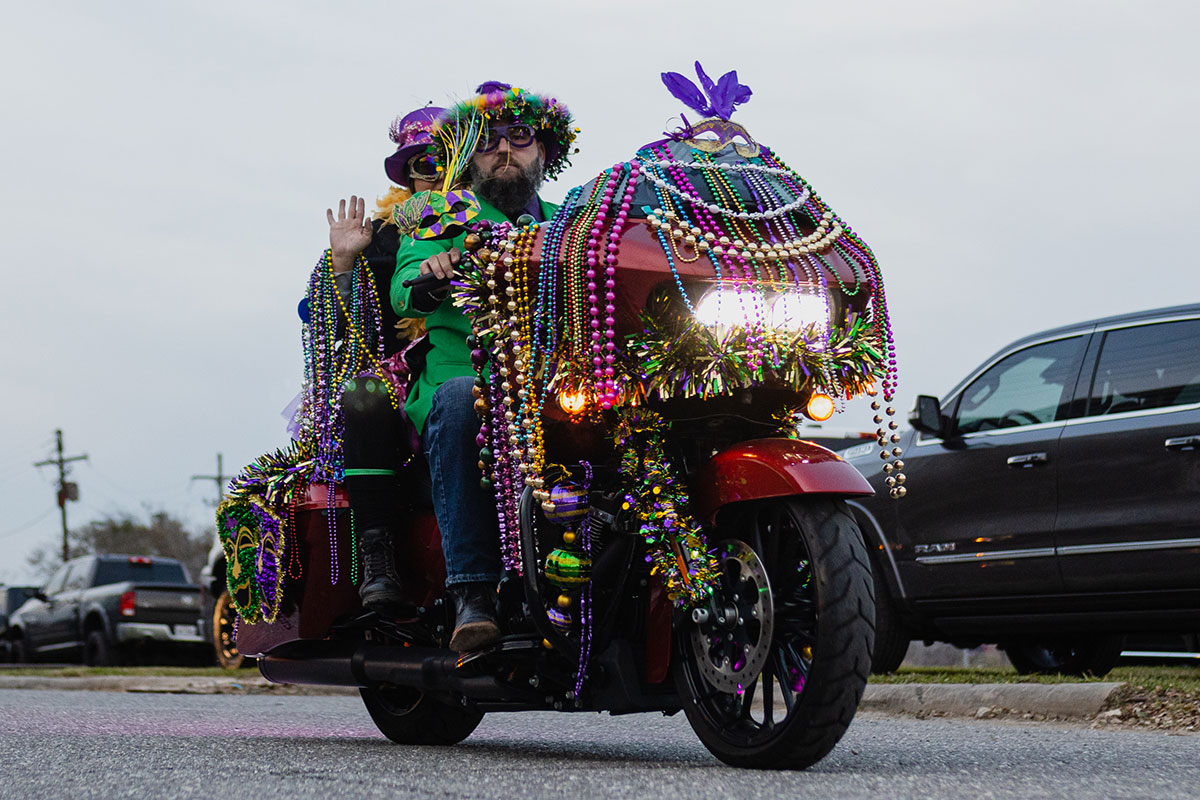 A biker drives off with motorcycle decorated with beads at the Mardi Gras of Southeast Texas, Feb. 18. UP photo by Brian Quijada.