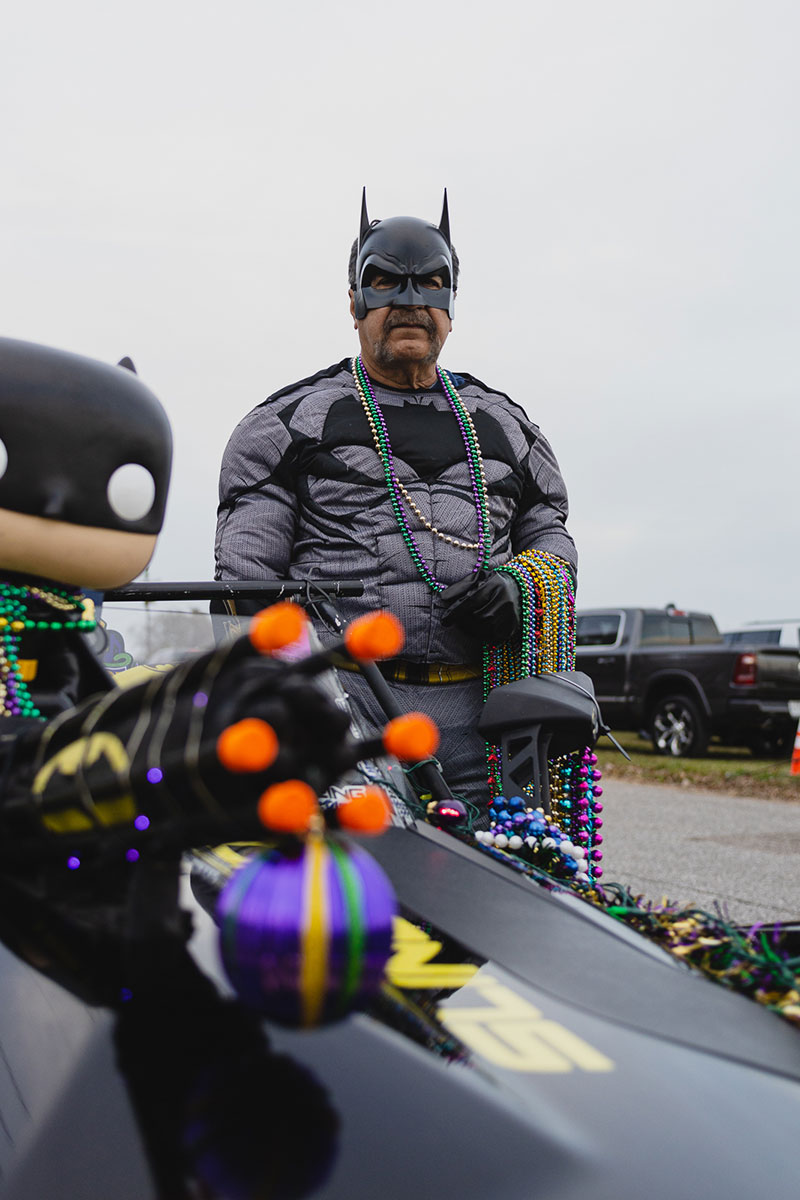 Johnny Colunga dressed as Batman poses for a picture in front of his 2018 Polaris Slingshot at the Mardi Gras of Southeast Texas, Feb. 18. UP photo by Brian Quijada.