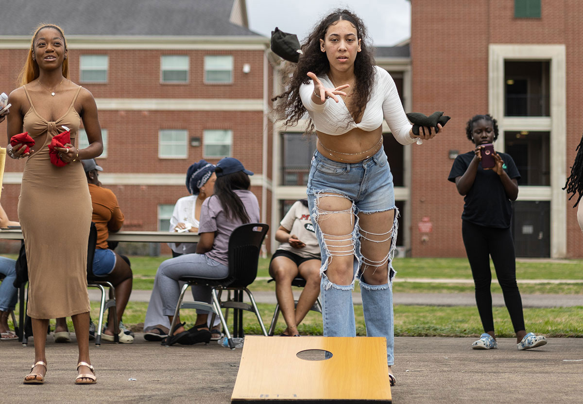 Students play cornhole while they wait for their food at the Black History Month Block Party, Feb. 24, at Cardinal Park. UP photo by Brian Quijada.