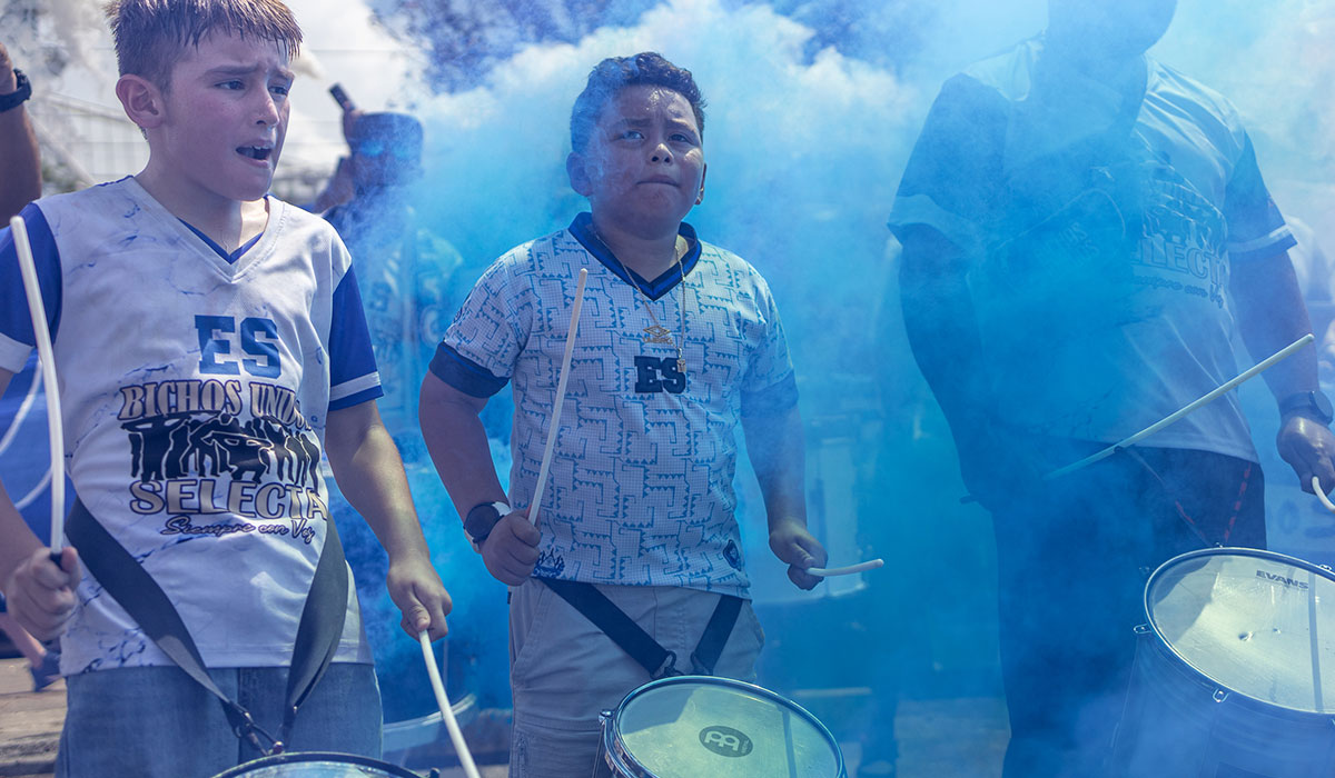 A child plays a drum with the fans and ultras in the parking lot outside of Shell Energy Stadium in Houston, July 4th. UP photo by Brian Quijada.