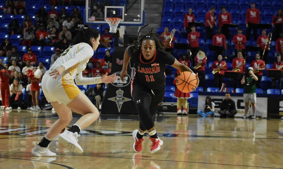 Portia Adams drives past a Lady Lions defender, March 9, at the Legacy Center in Lake Charles, Louisiana. Photo credit: Keagan Smith, UP sports editor.