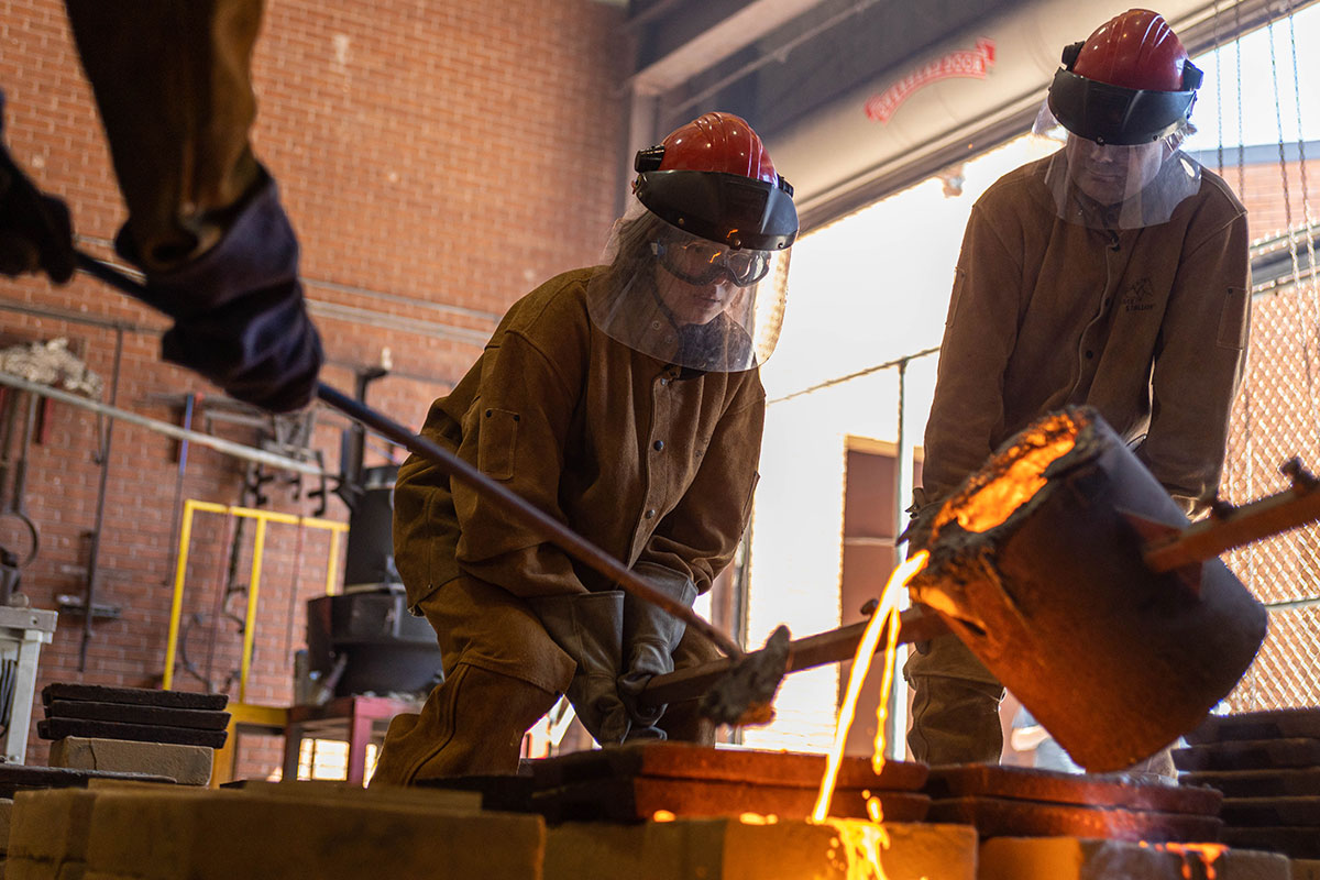 LU student Brithany Landeros pours the molten iron into the sand mold, March 3, at the art foundry. UP photo by Brian Quijada.